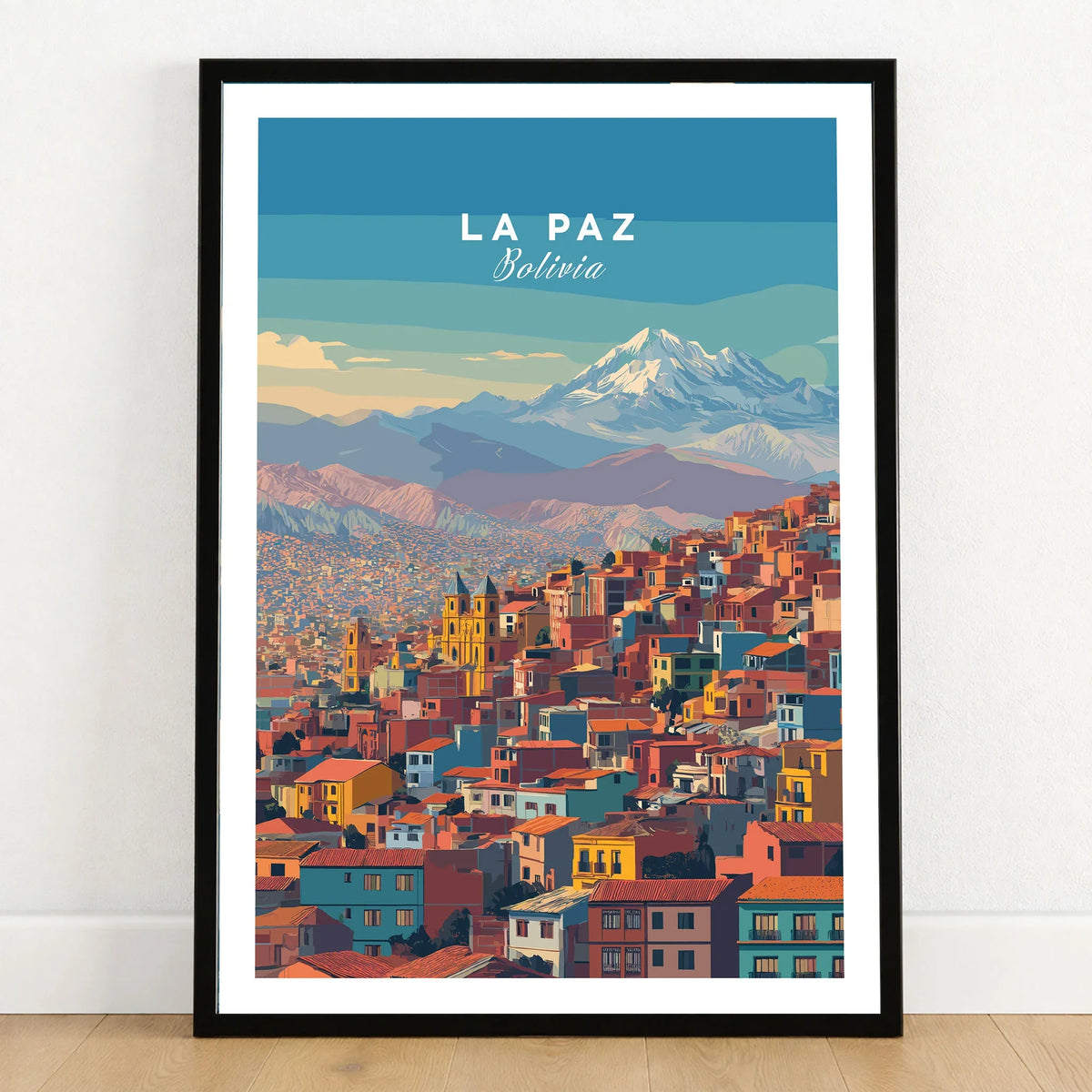 La Paz Bolivia Andes Mountain City Print - Travel Poster in a black wooden frame leaning against a white wall on a light wooden floor