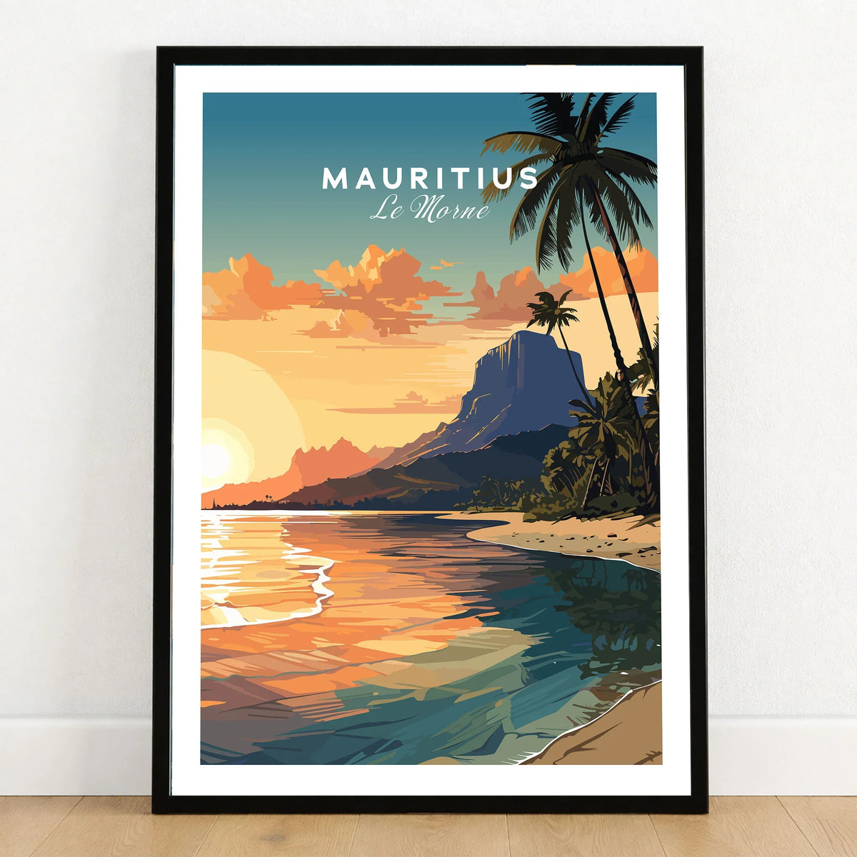 Le Morne Mauritius Poster in a black wooden frame leaning against a white wall on a light wooden floor