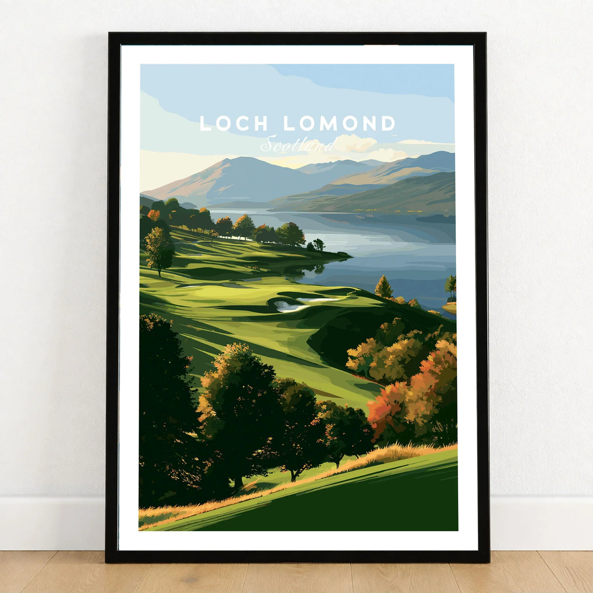Loch Lomond Scotland Autumn Lochside Travel Poster — autumn slopes rolling down to Loch Lomond with Highland hills beyond, shown as art print in black frame on wooden floor