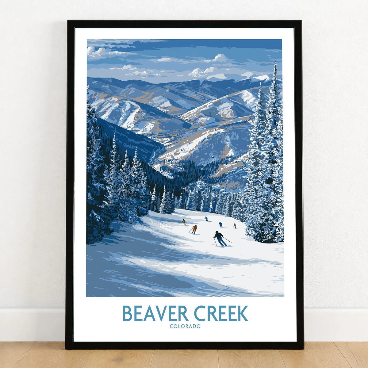 Beaver Creek Colorado Winter Wonderland Wall Art - Group Skiing Landscape in a black wooden frame leaning against a white wall on a light wooden floor
