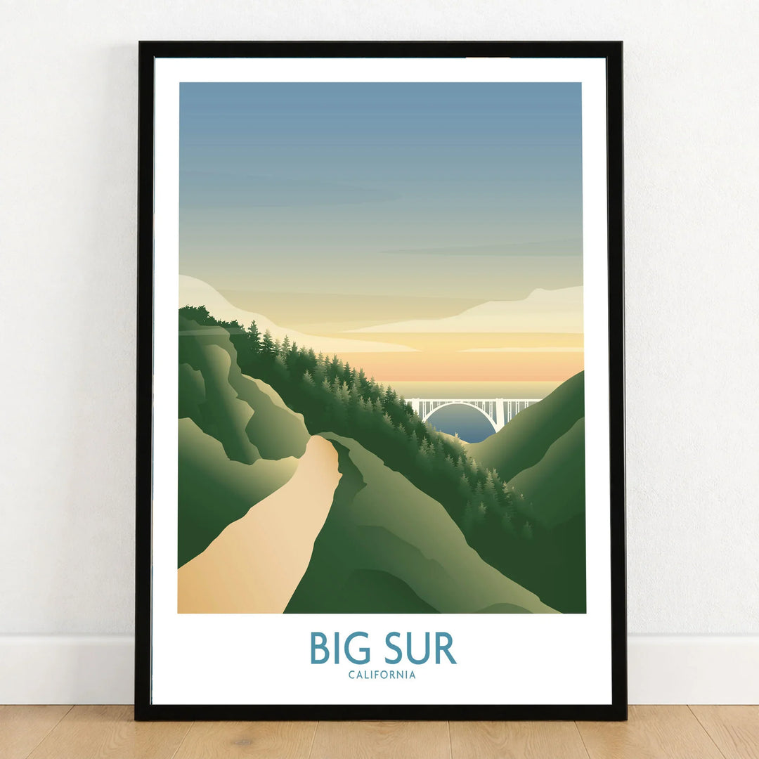 Big Sur California Art Print in a black wooden frame leaning against a white wall on a light wooden floor