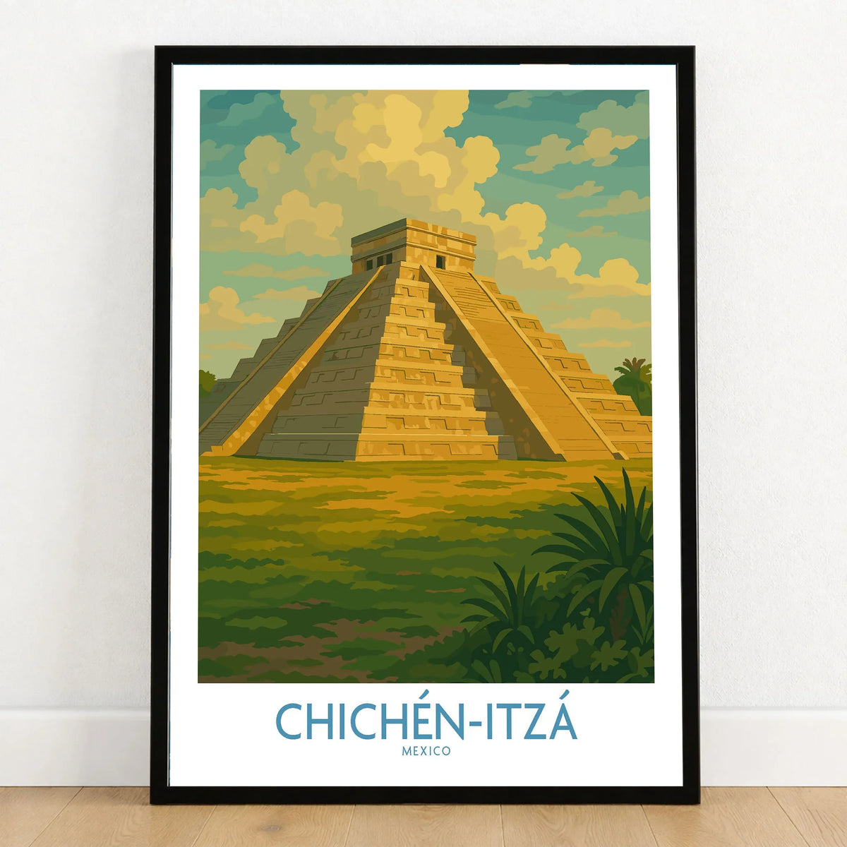 Mexico Mayan Pyramid Chichén Itzá Travel Poster El Castillo Landscape Print Wall Art in a black wooden frame leaning against a white wall on a light wooden floor