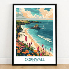 Cornwall Travel Poster - United Kingdom in a black wooden frame leaning against a white wall on a light wooden floor