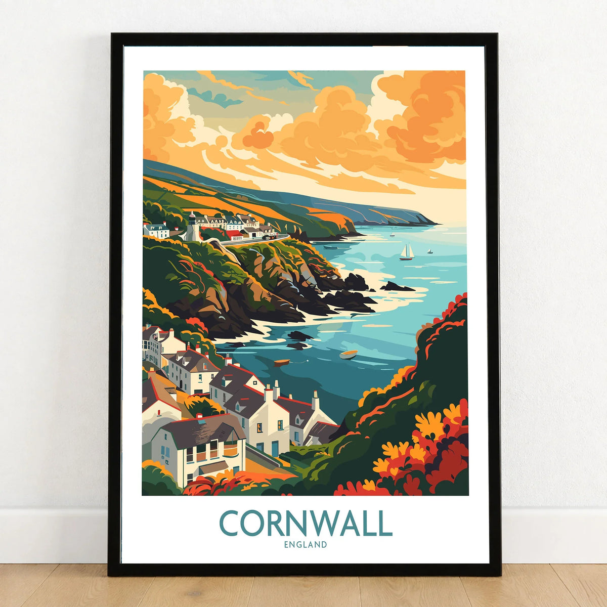 Cornwall Art Print - Modern in a black wooden frame leaning against a white wall on a light wooden floor