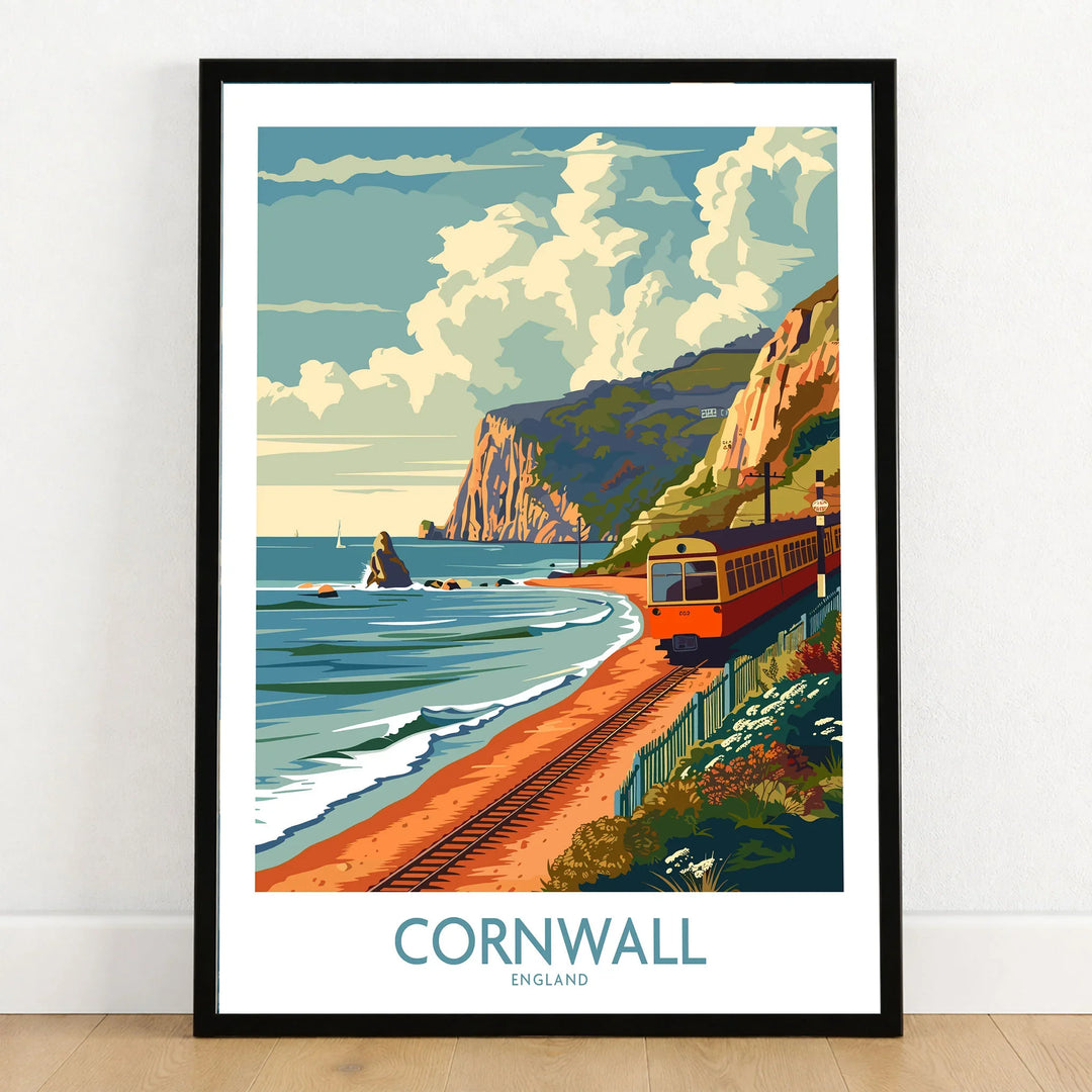 Cornwall Coast Wall Art Print in a black wooden frame leaning against a white wall on a light wooden floor