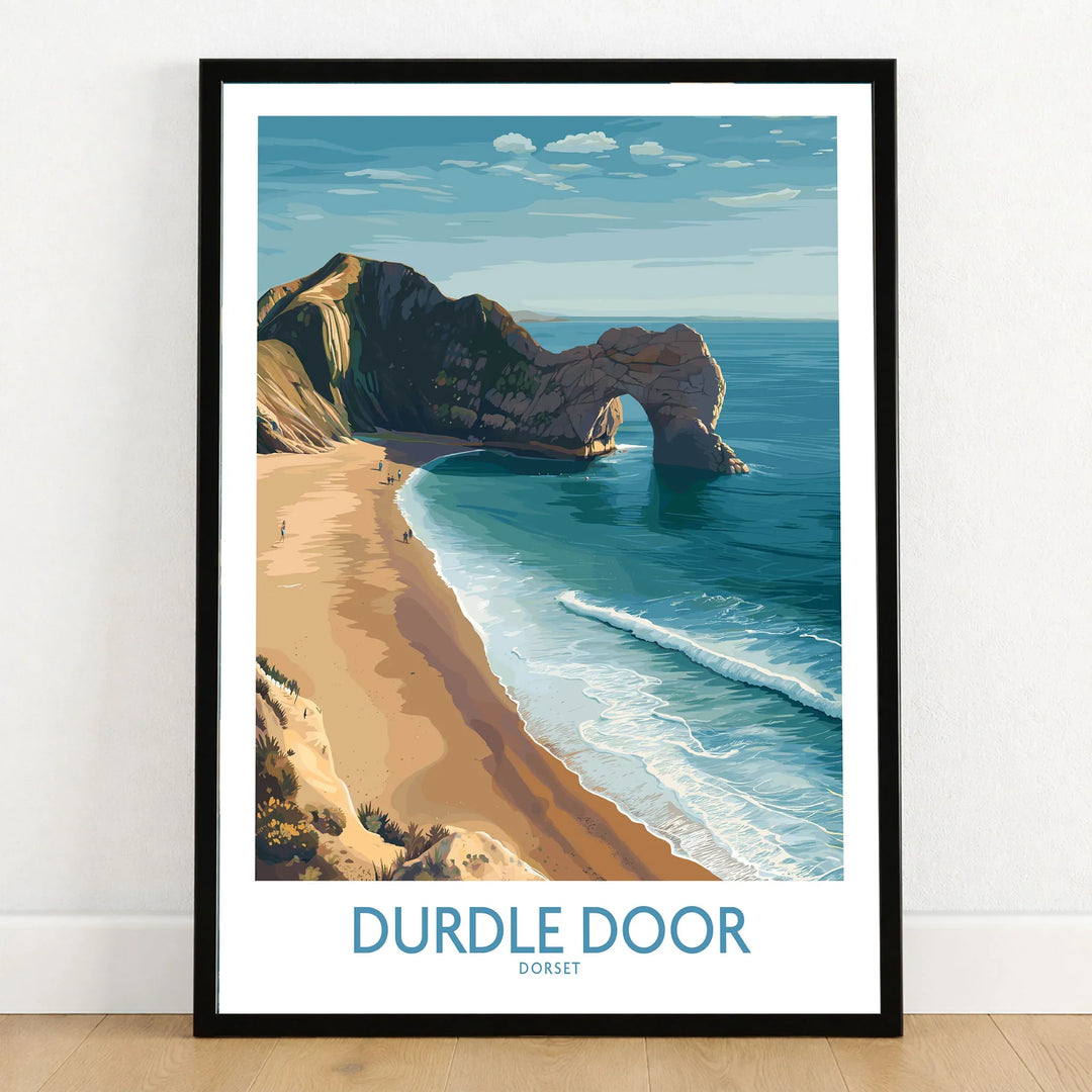 Durdle Door Art Print Dorset Wall Art in a black wooden frame leaning against a white wall on a light wooden floor