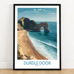 Durdle Door Art Print Dorset Wall Art in a black wooden frame leaning against a white wall on a light wooden floor