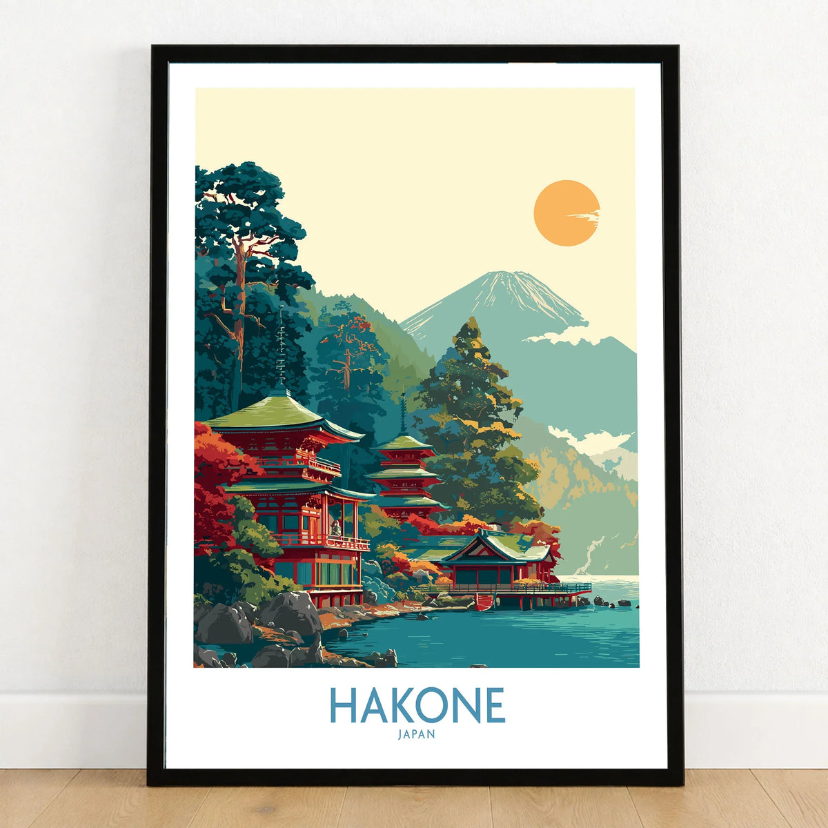 Hakone Japan Lake Ashi Temple Print - Japanese Pagoda Wall Art - Modern in a black wooden frame leaning against a white wall on a light wooden floor