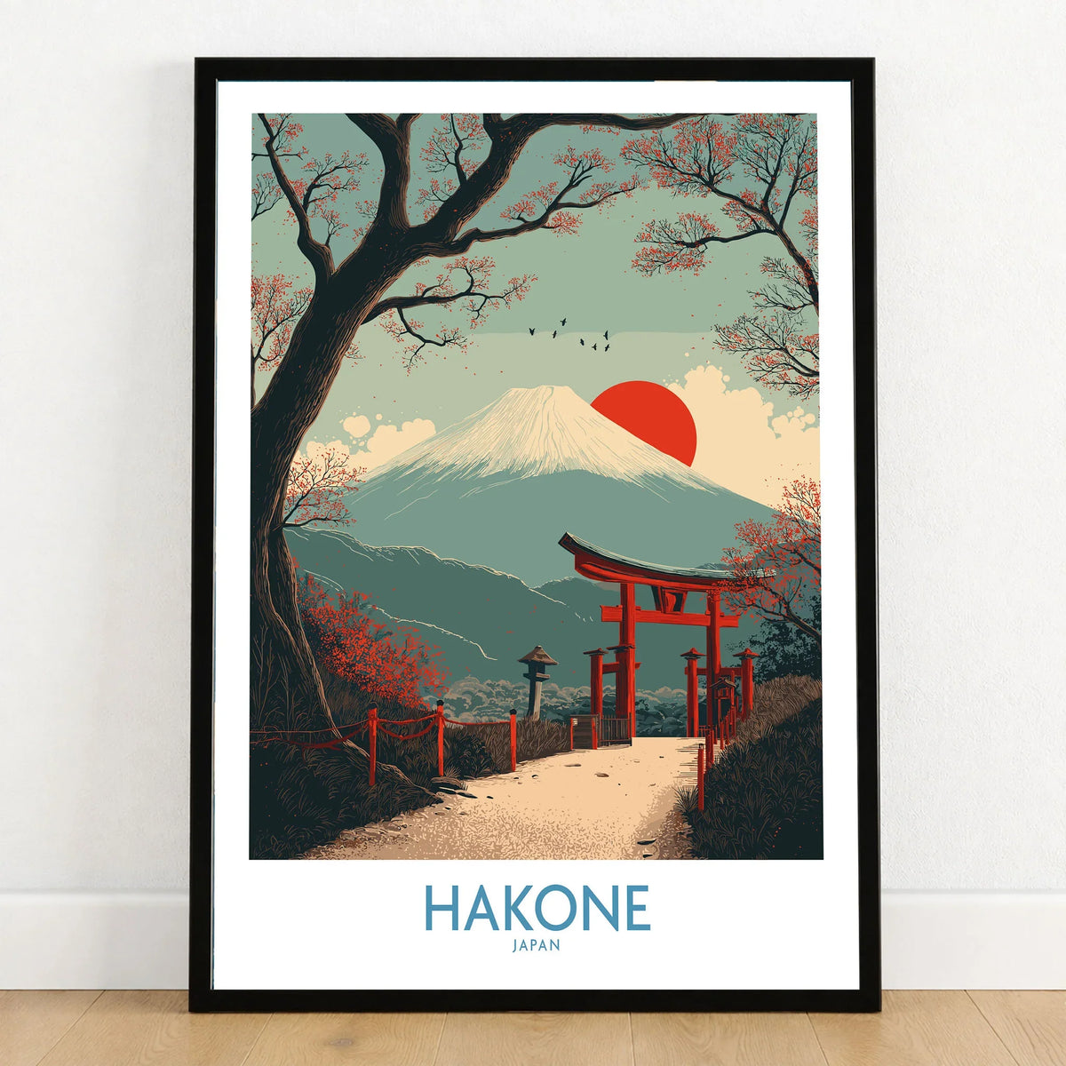 Hakone Japan Peace Gate Shrine Wall Art - Autumn Cherry Blossom Decor in a black wooden frame leaning against a white wall on a light wooden floor