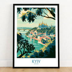 Kyiv Ukraine Dnipro River Wall Art — golden domes on a wooded bluff above the Dnipro river, shown as art print in black frame on wooden floor