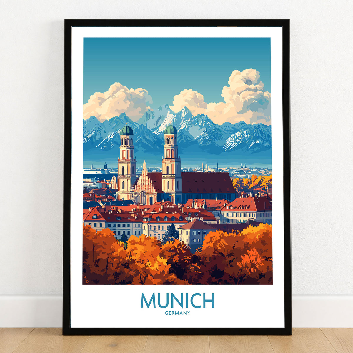 Munich Travel Poster in a black wooden frame leaning against a white wall on a light wooden floor