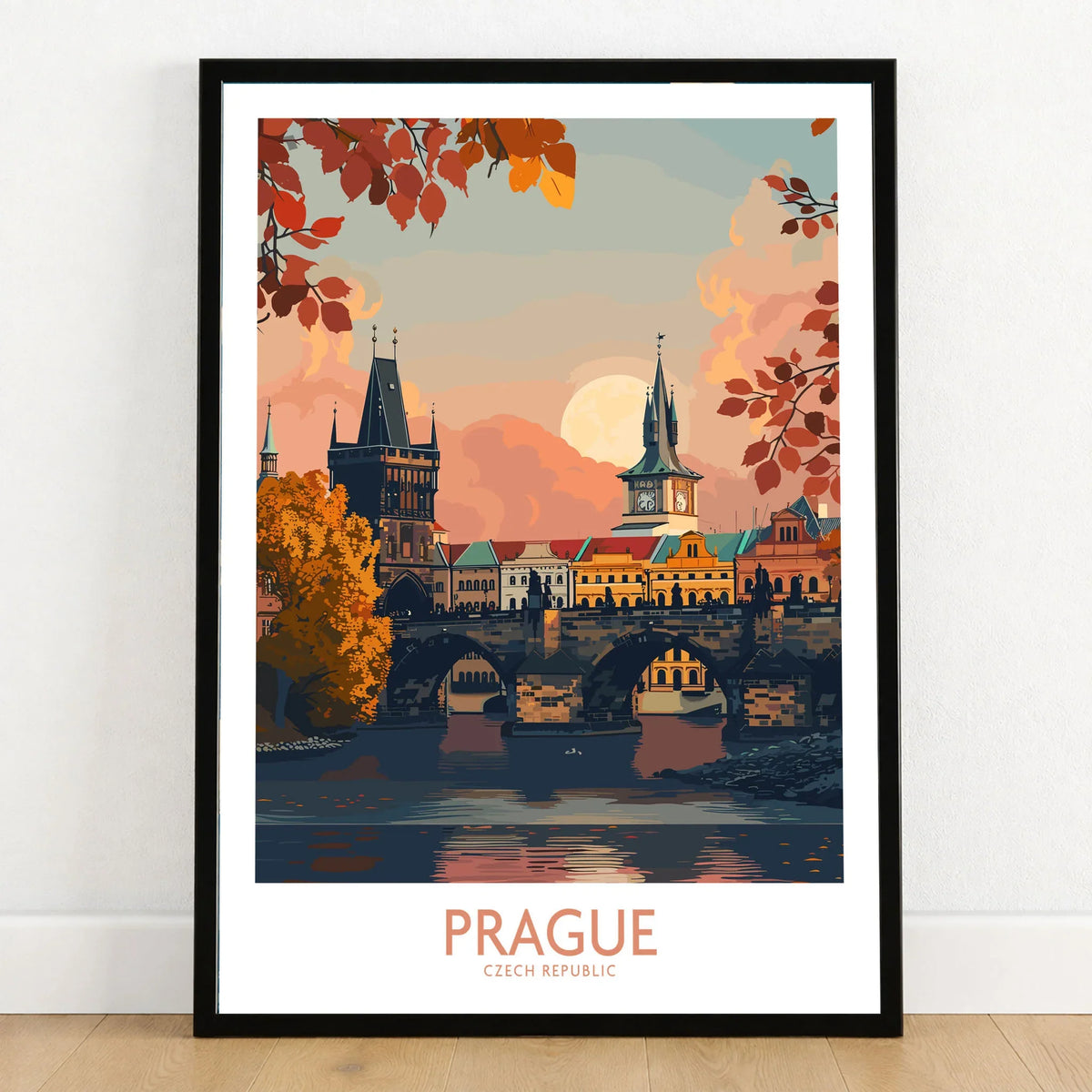 Prague Travel Print in a black wooden frame leaning against a white wall on a light wooden floor
