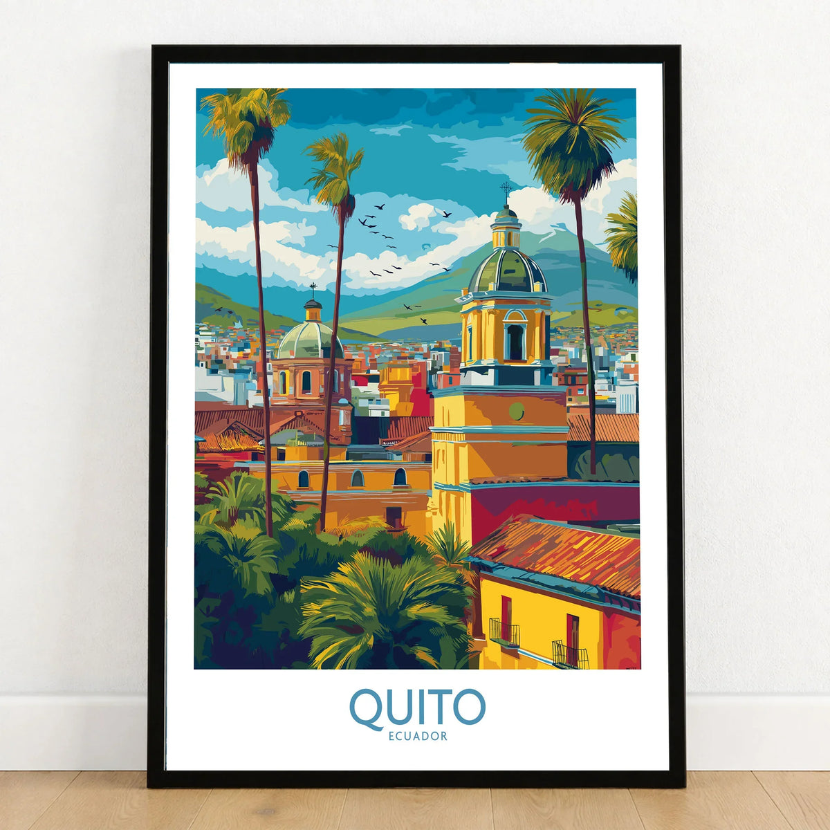 Ecuador Quito Cityscape Travel Print Poster Colonial Churches Andes Mountain Wall Art in a black wooden frame leaning against a white wall on a light wooden floor