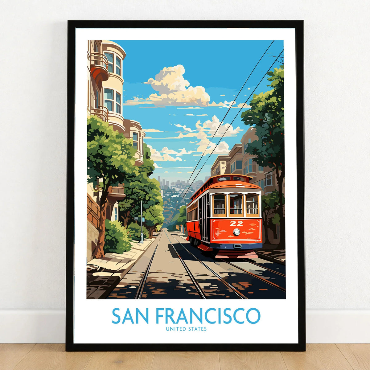 San Francisco Wall Prints in a black wooden frame leaning against a white wall on a light wooden floor