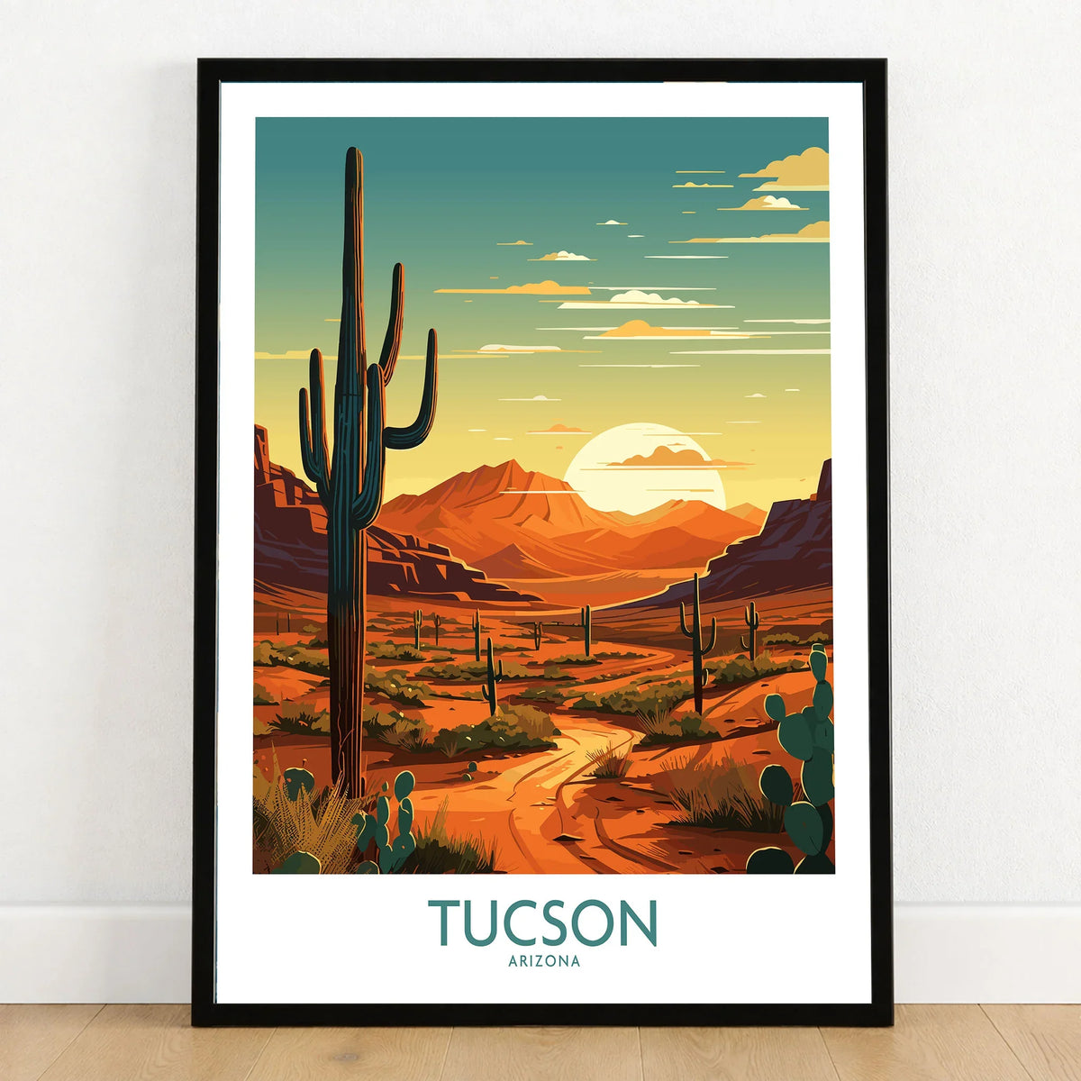 Tucson Art Print in a black wooden frame leaning against a white wall on a light wooden floor