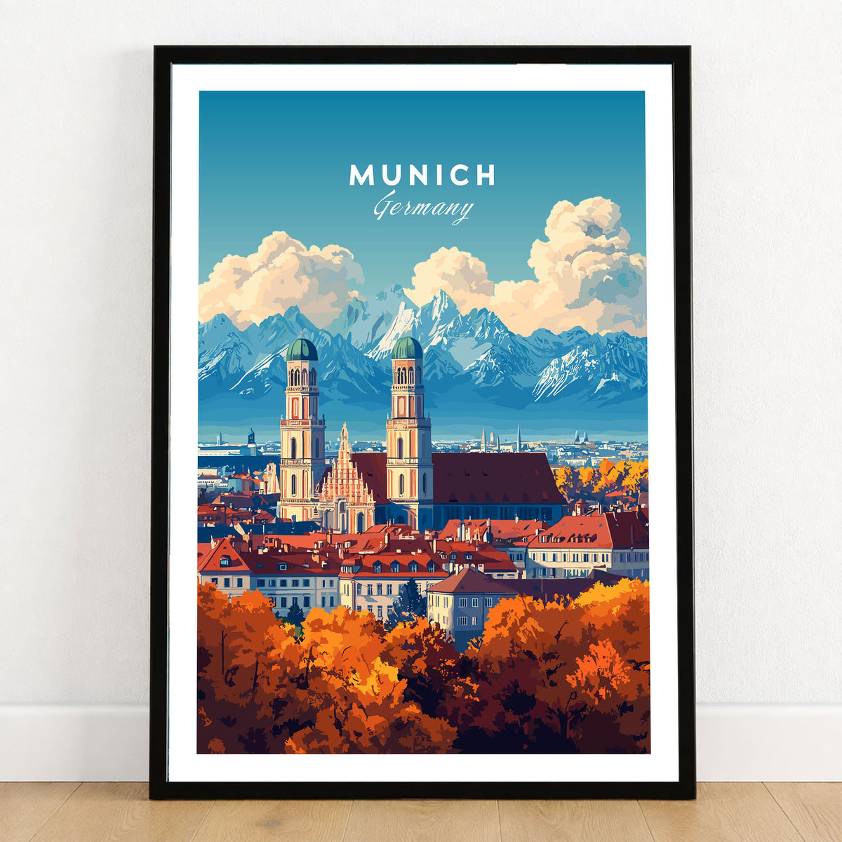 Munich Travel Print in a black wooden frame leaning against a white wall on a light wooden floor