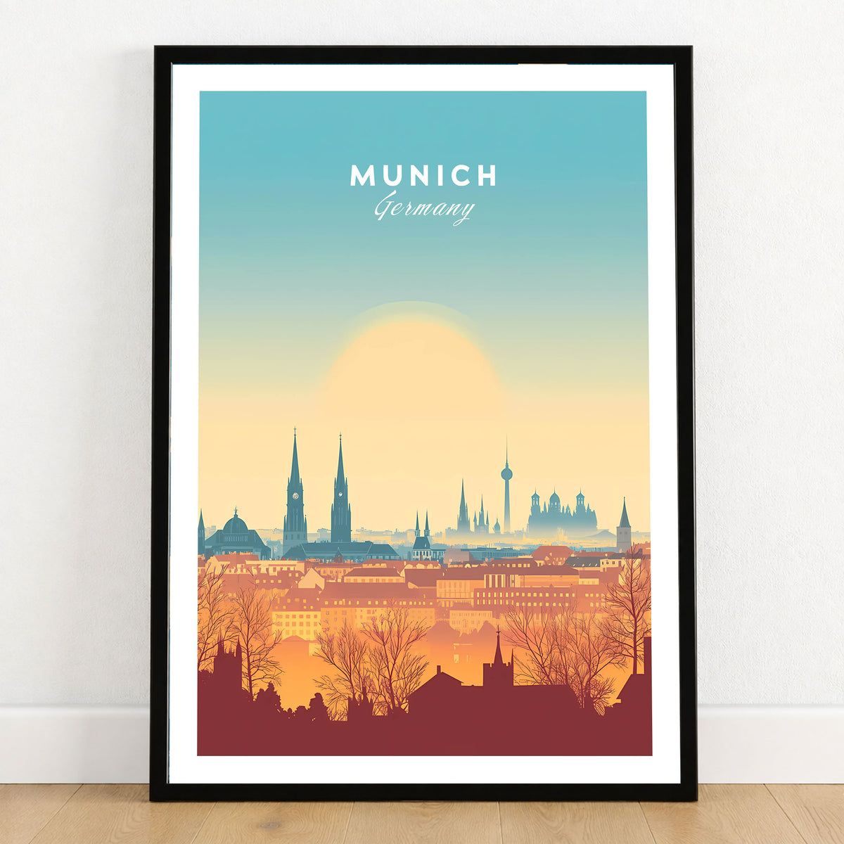 Munich Wall Art in a black wooden frame leaning against a white wall on a light wooden floor