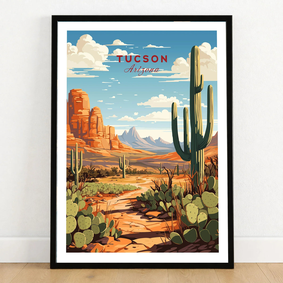 Tucson Arizona Print in a black wooden frame leaning against a white wall on a light wooden floor