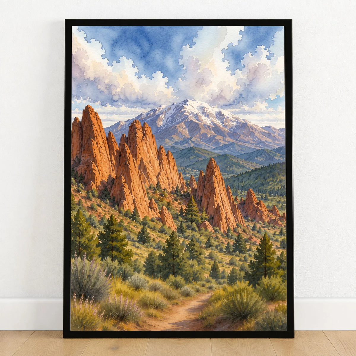 Garden of the Gods red rocks and Pikes Peak watercolour art print in a black frame on a wooden floor