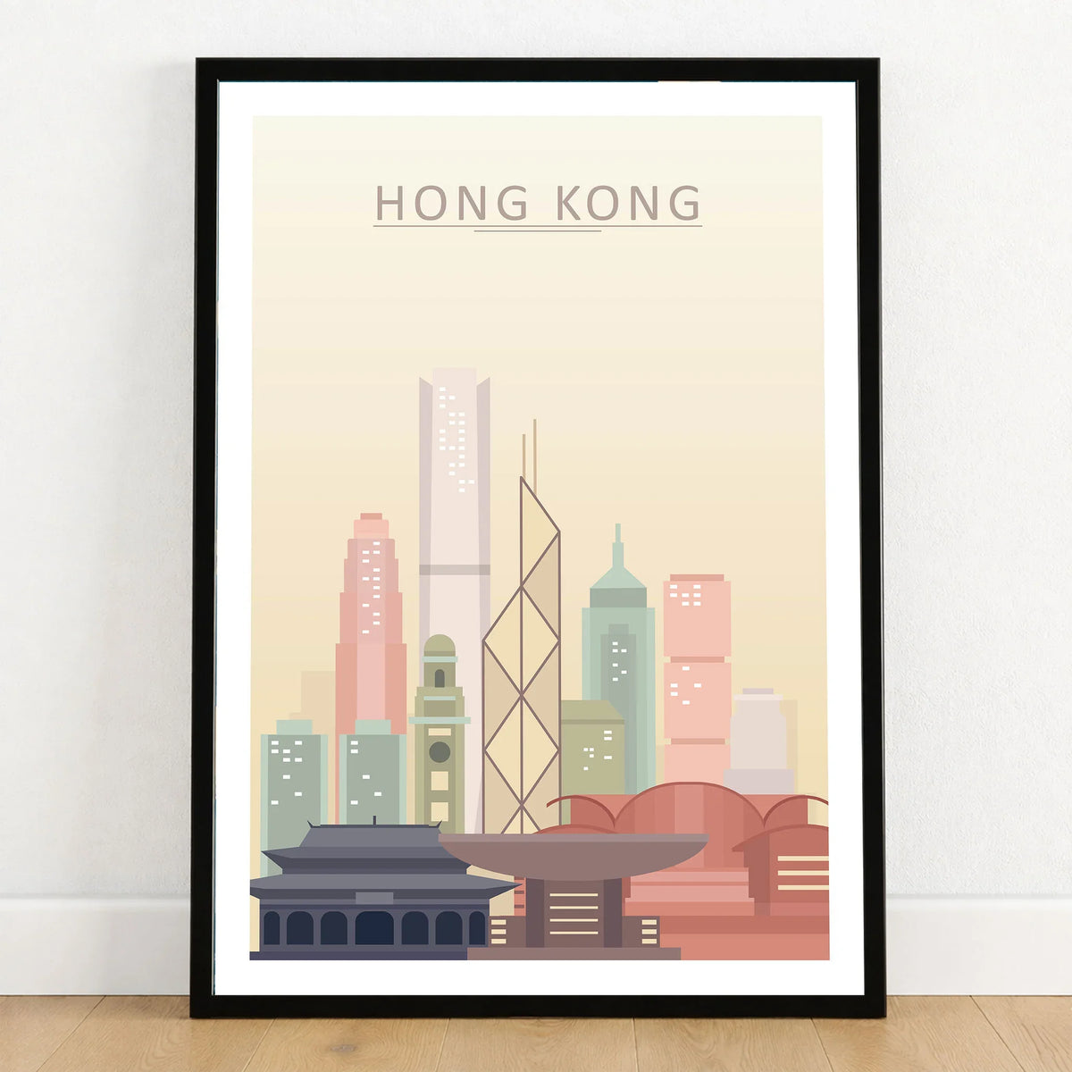 Hong Kong city skyline art print in a black frame on a wooden floor