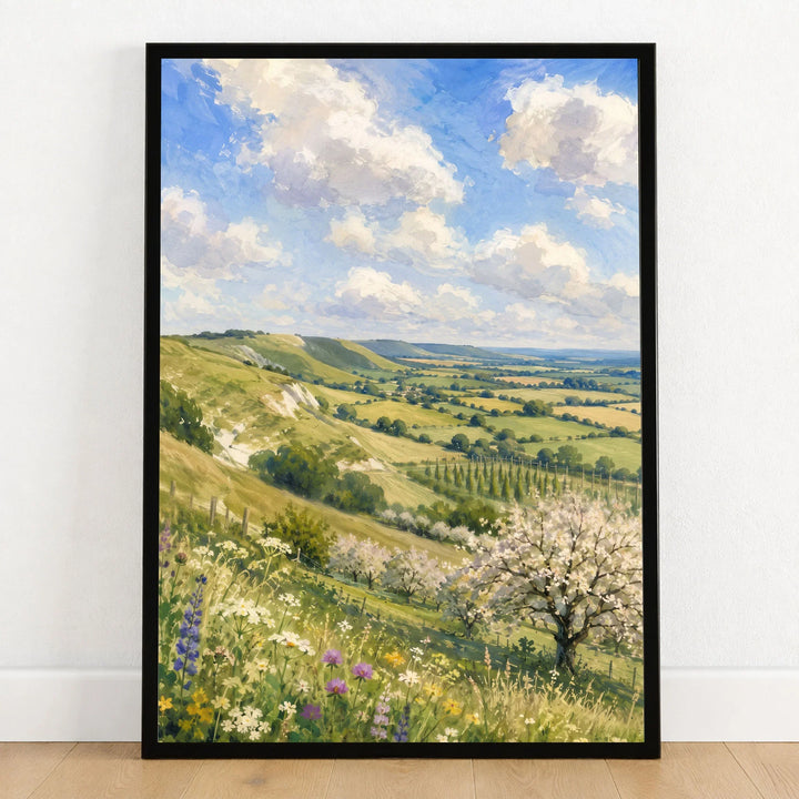 Kent Downs chalk downs and orchard blossom watercolour art print in a black frame on a wooden floor