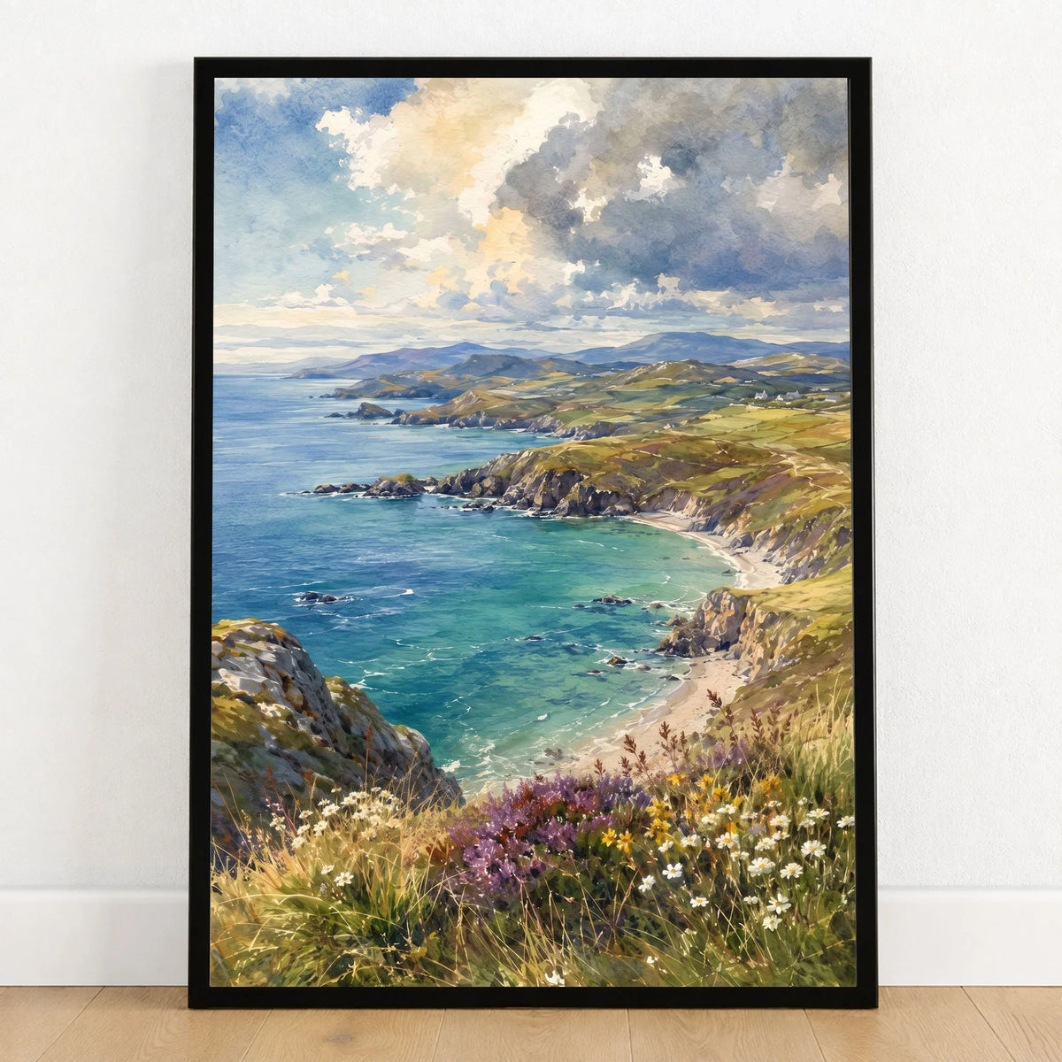 Llyn Peninsula sandy cove and coastline watercolour art print in a black frame on a wooden floor