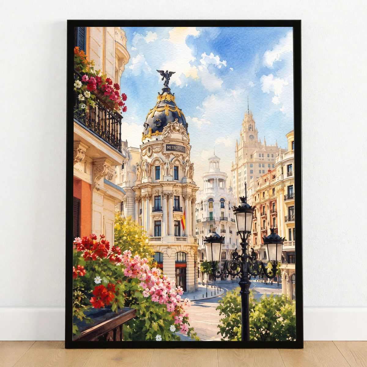 Madrid Metropolis building on Gran Vía watercolour art print in a black frame on a wooden floor