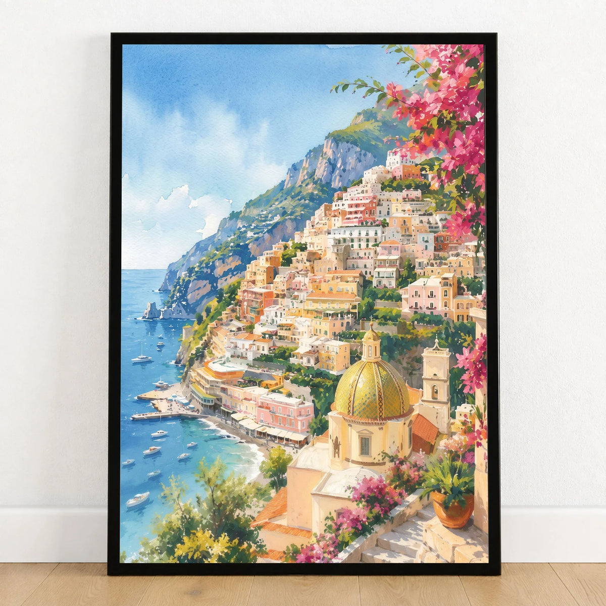 Positano cliffside village and church dome watercolour art print in a black frame on a wooden floor