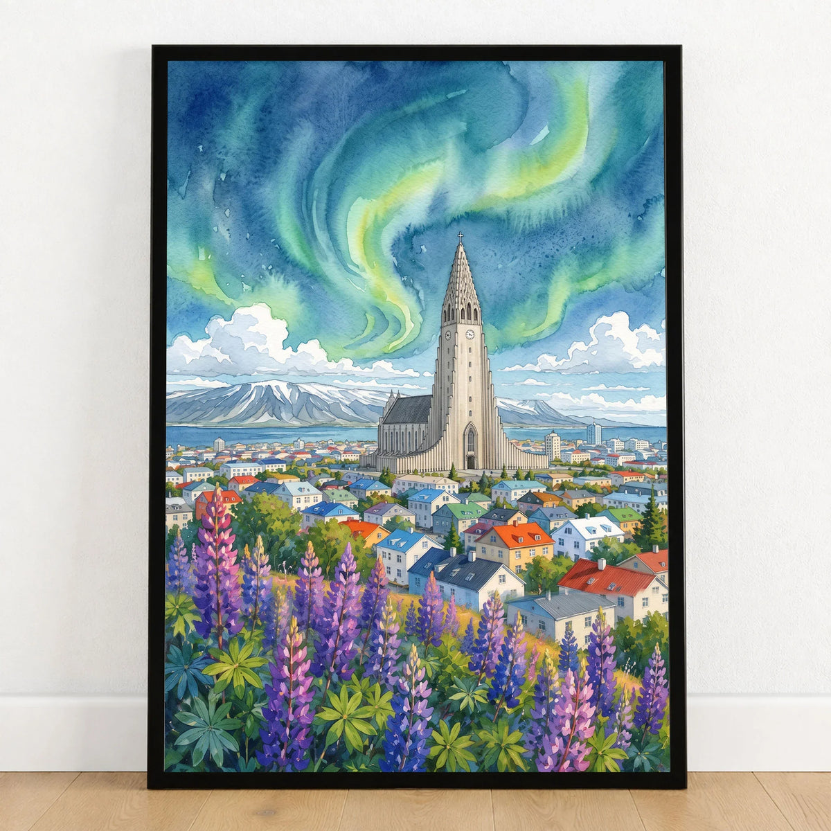Reykjavik Hallgrímskirkja and northern lights watercolour art print in a black frame on a wooden floor