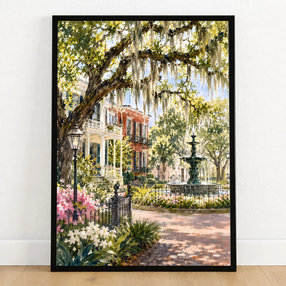 Savannah Spanish moss oaks and park fountain watercolour art print in a black frame on a wooden floor