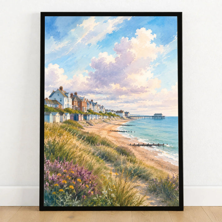 Suffolk Coast Southwold pier and beach huts watercolour art print in a black frame on a wooden floor