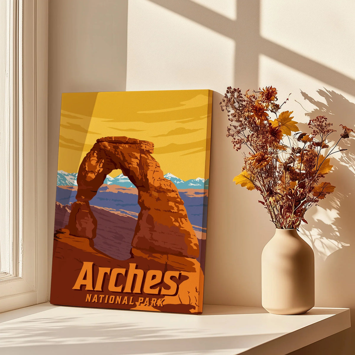 Arches National Park canvas print with Delicate Arch, vase of dried flowers, sunlit window.