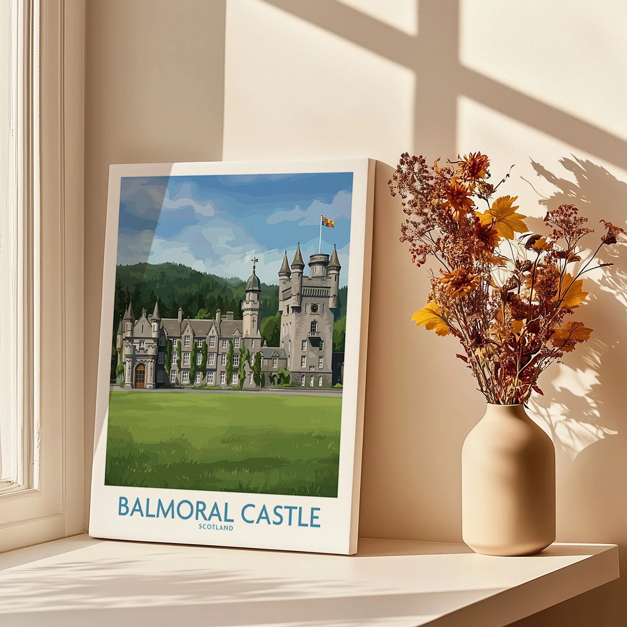 Balmoral Castle travel poster on windowsill with vase of flowers and sunlight shadows