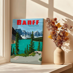 Banff National Park canvas wall art with mountain lake scene beside vase of dried flowers in sunlight