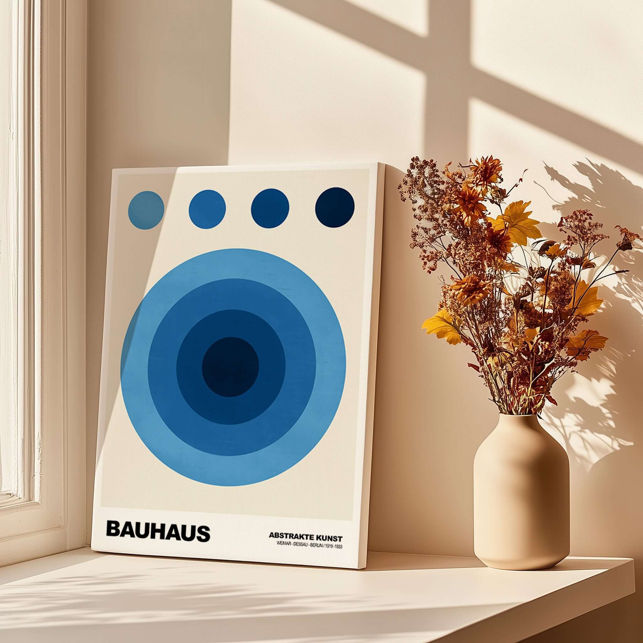 Bauhaus Exhibition Prints - Abstract Blue Circles Poster Geometric Design displayed on a windowsill with flowers.