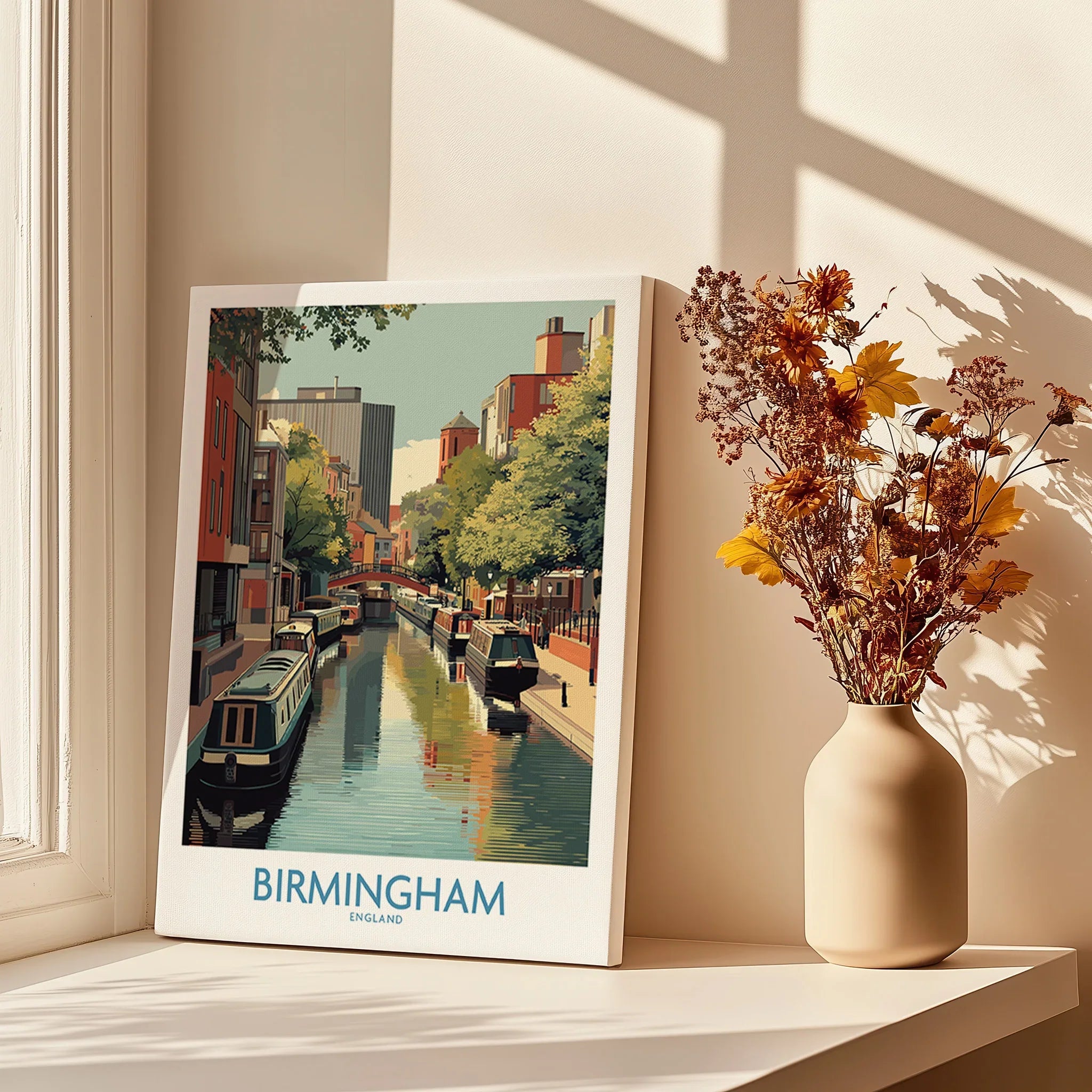 Birmingham city canal travel poster print on a windowsill with vase of dried flowers