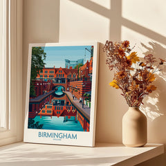 Birmingham cityscape travel poster on windowsill with vase of dried flowers and shadows