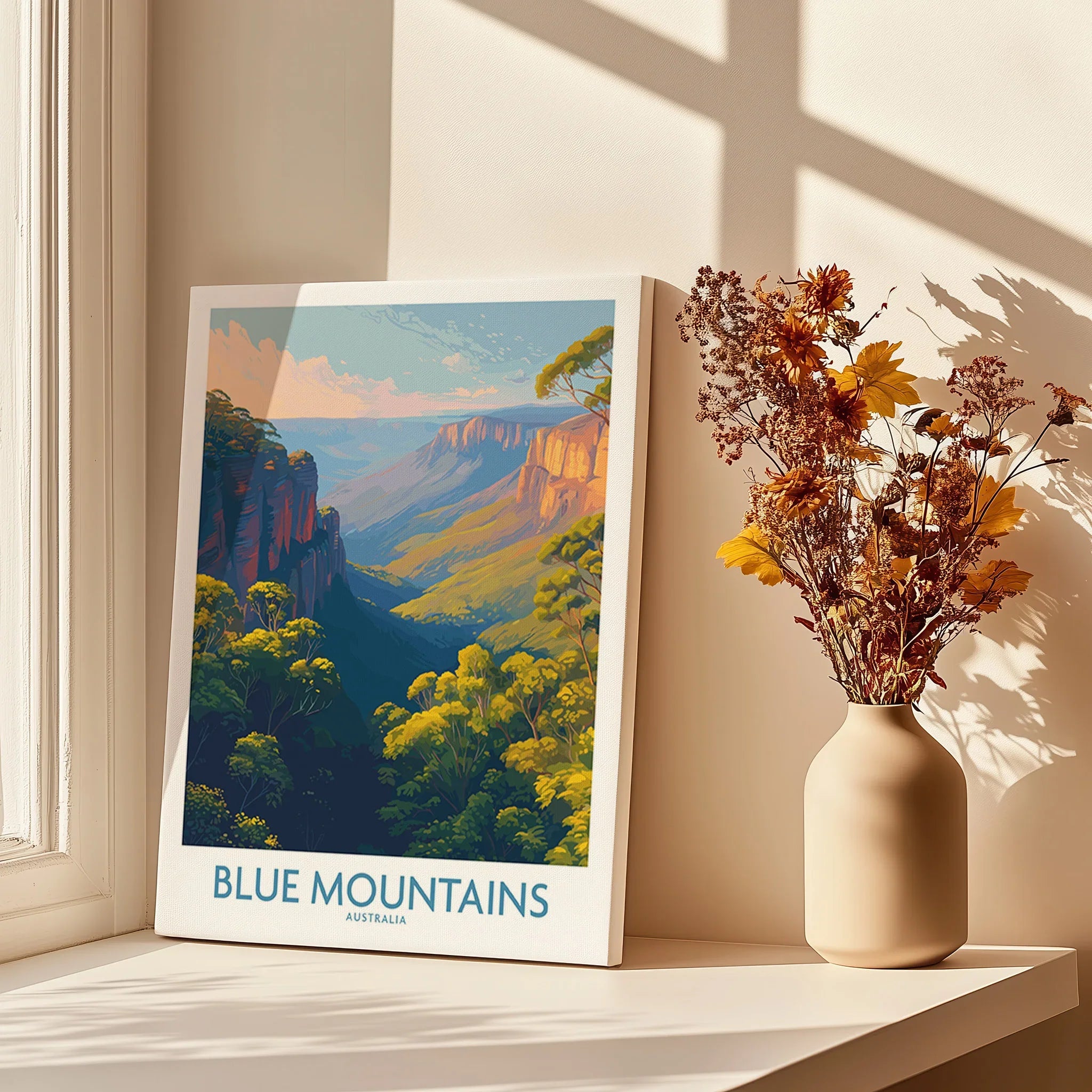 Blue Mountains Australia travel poster on windowsill with vase of dried flowers, sunlight and shadows