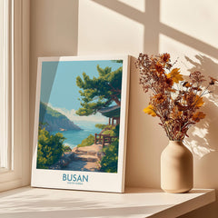 Busan South Korea travel poster print on windowsill with vase of dried flowers and shadows