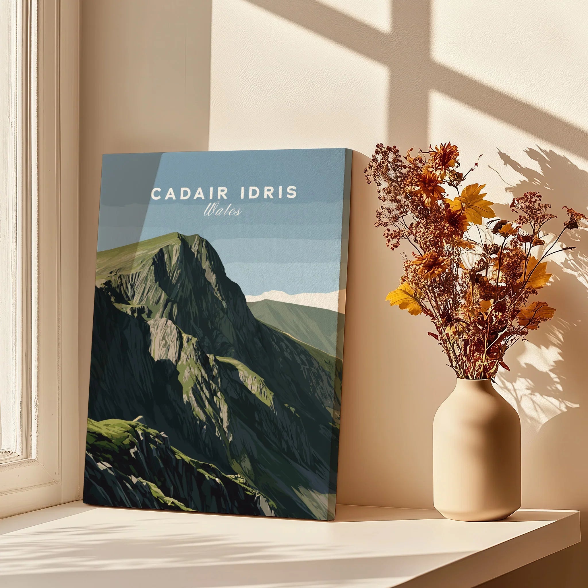 Canvas print of Cadair Idris Wales mountain art by window with vase of yellow flowers.