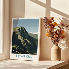 Canvas print of Cadair Idris Wales mountain poster beside vase with dried flowers on sunlit windowsill