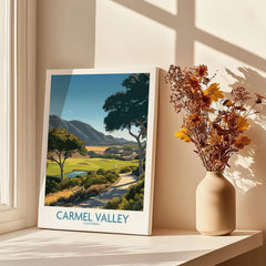 Carmel Valley California travel poster print by a sunlit window, with shadows and dried flowers in vase