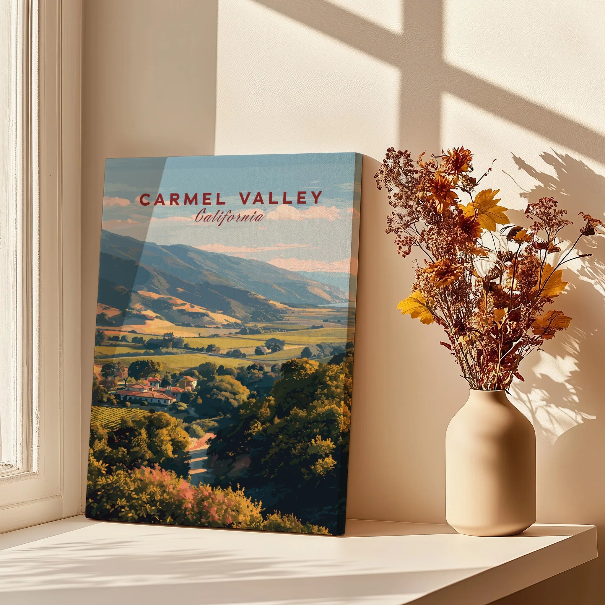 Carmel Valley California canvas print with landscape art beside a vase of dried flowers on a sunlit shelf