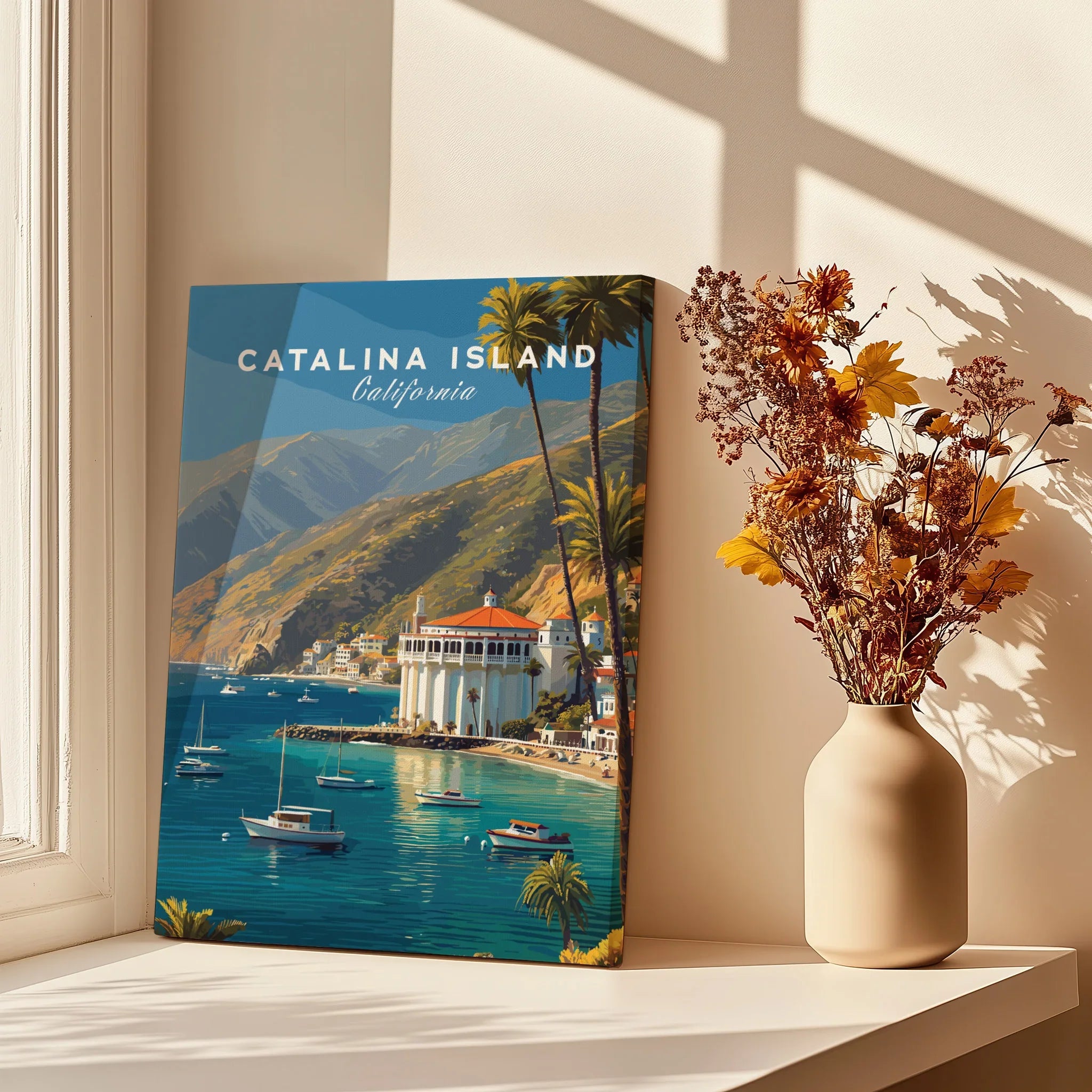Catalina Island travel poster canvas on windowsill beside vase with dried flowers in sunlight