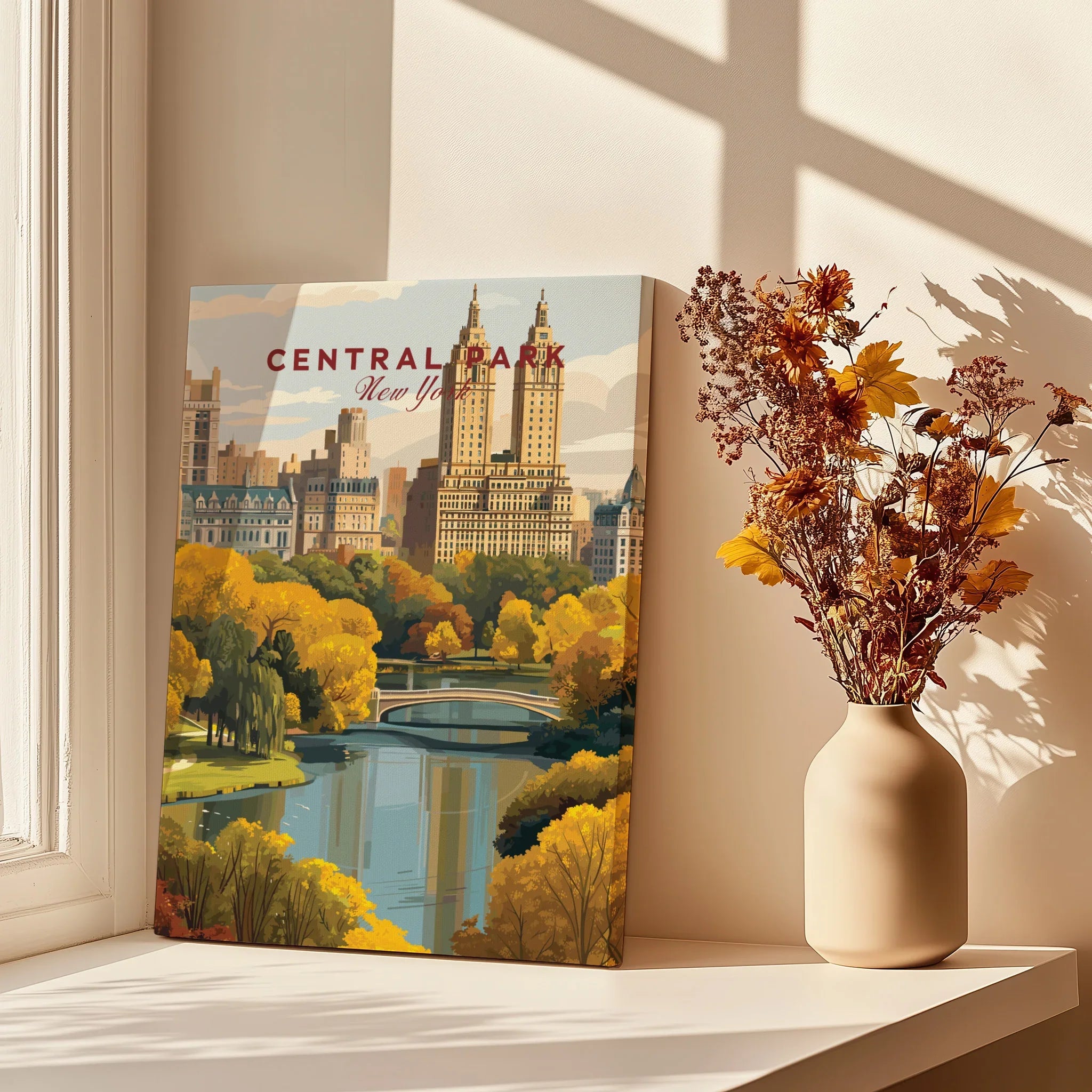 Central Park New York art print with skyline, autumn trees, and bridge beside vase of dried flowers