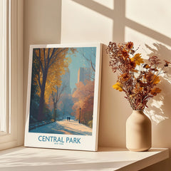 Central Park art print on windowsill with autumn leaves and city skyline, dried flowers in vase