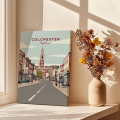 Colchester England travel poster canvas print on windowsill with vase of dried flowers