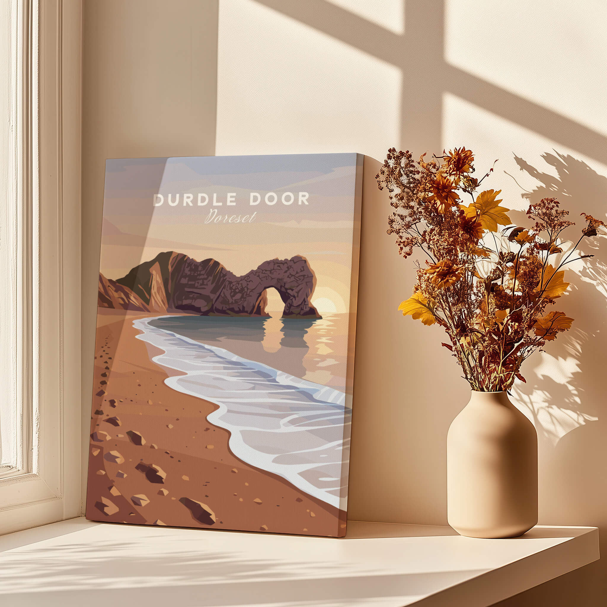 Durdle Door Travel Poster – Jurassic Coast Sunset Art displayed on a table with a vase of flowers in a sunlit room.