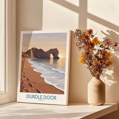 Durdle Door Dorset Wall Art – Canvas Poster displayed in a sunlit room next to a vase of flowers.