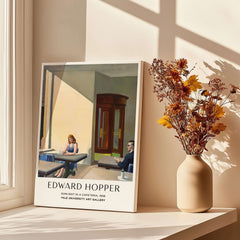 Edward Hopper Sunlight in a Cafeteria 1958 Yale Art Gallery Print displayed on a table with flowers in a vase.